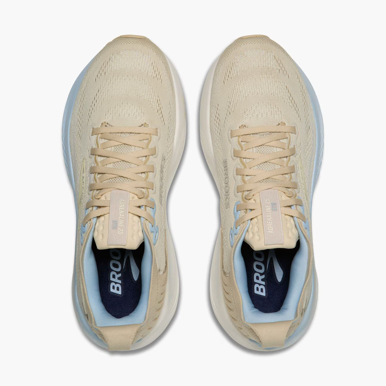 Pair of beige Brooks Women's Adrenaline GTS 25 running shoes with blue accents on a white background