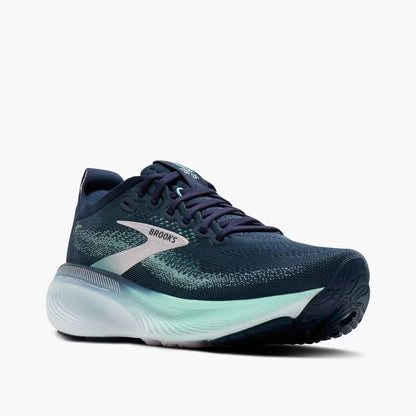 Navy running shoe with green sole on a white background