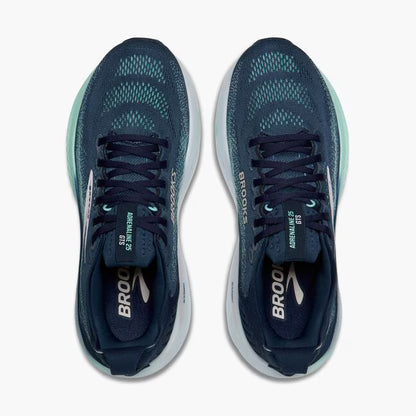 Pair of navy running shoes with white soles on a white background