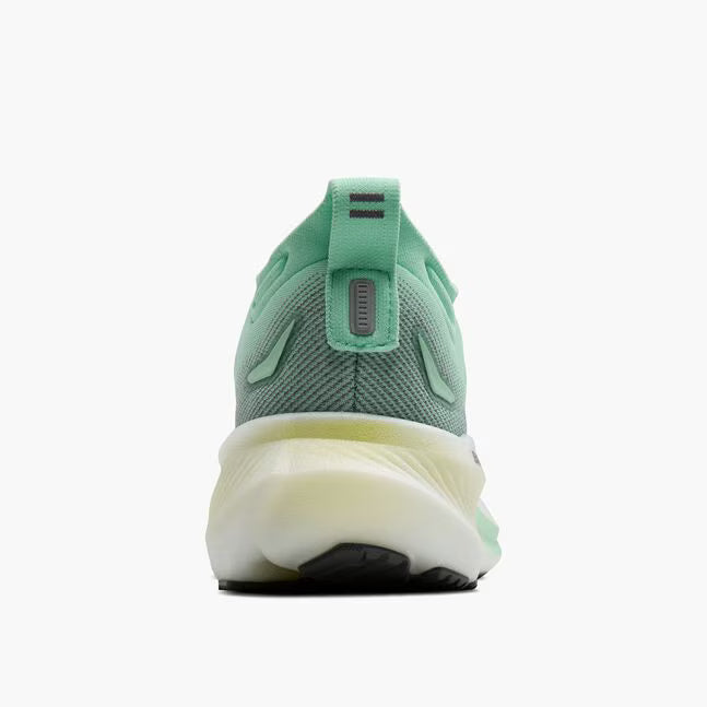 Green running shoe with a white sole on a white background