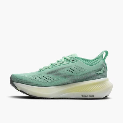 Green running shoe with white sole on a white background