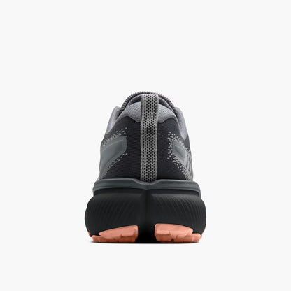Black and gray athletic shoe with pink sole on a white background