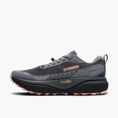 A dark gray and black trail running shoe with a thick black midsole and dusty rose accents on the outsole and branding, shown from a side profile on a light gray background.