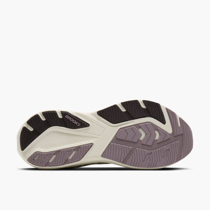 The outsole of a Brooks Ghost Amp running shoe, showing a cream-colored midsole with black and dusty purple-gray tread patterns.