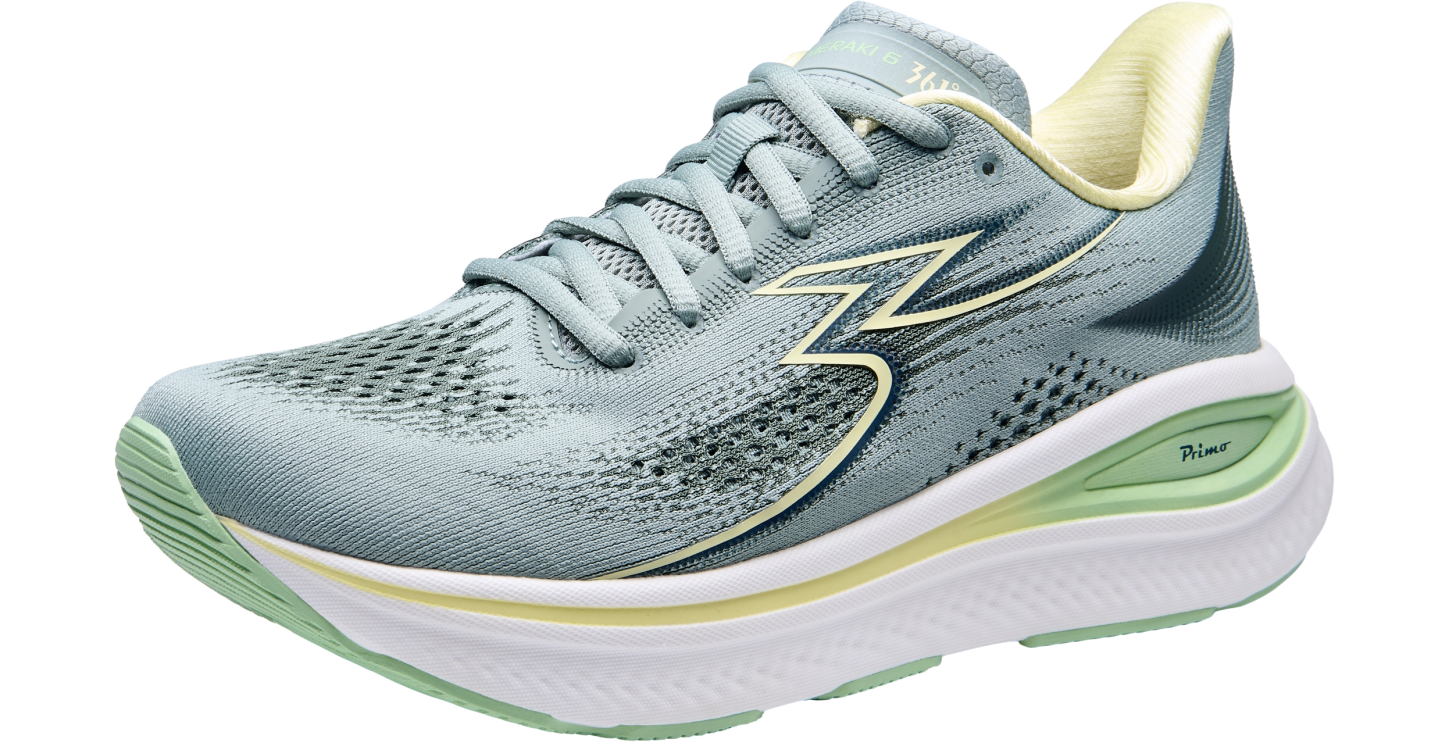 Light blue running shoe with green accents on a white background
