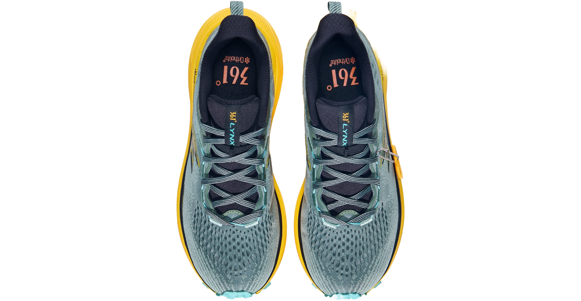 Pair of running shoes with yellow accents on a white background