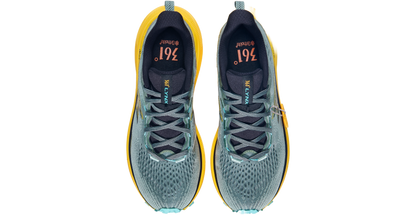 Pair of running shoes with yellow accents on a white background