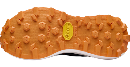 Close-up of a shoe sole with orange tread pattern and Vibram logo on a white background