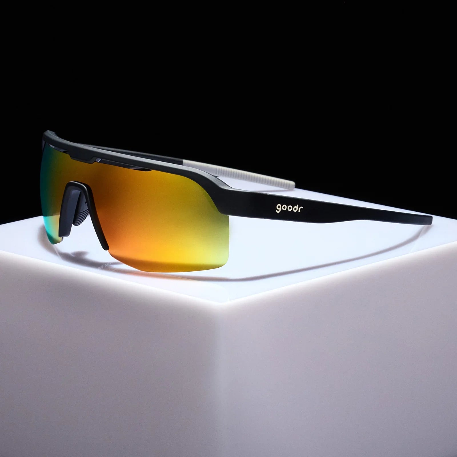 Goodr Bolt G: Do It For The Victory Dance wraparound Sunglasses with reflective yellow lenses on a white surface with a black background