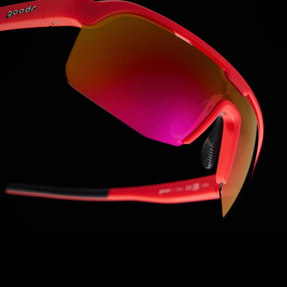 Goodr Bolt G: Dante’s Shin Splint Inferno Red sunglasses with a reflective lens on a black background