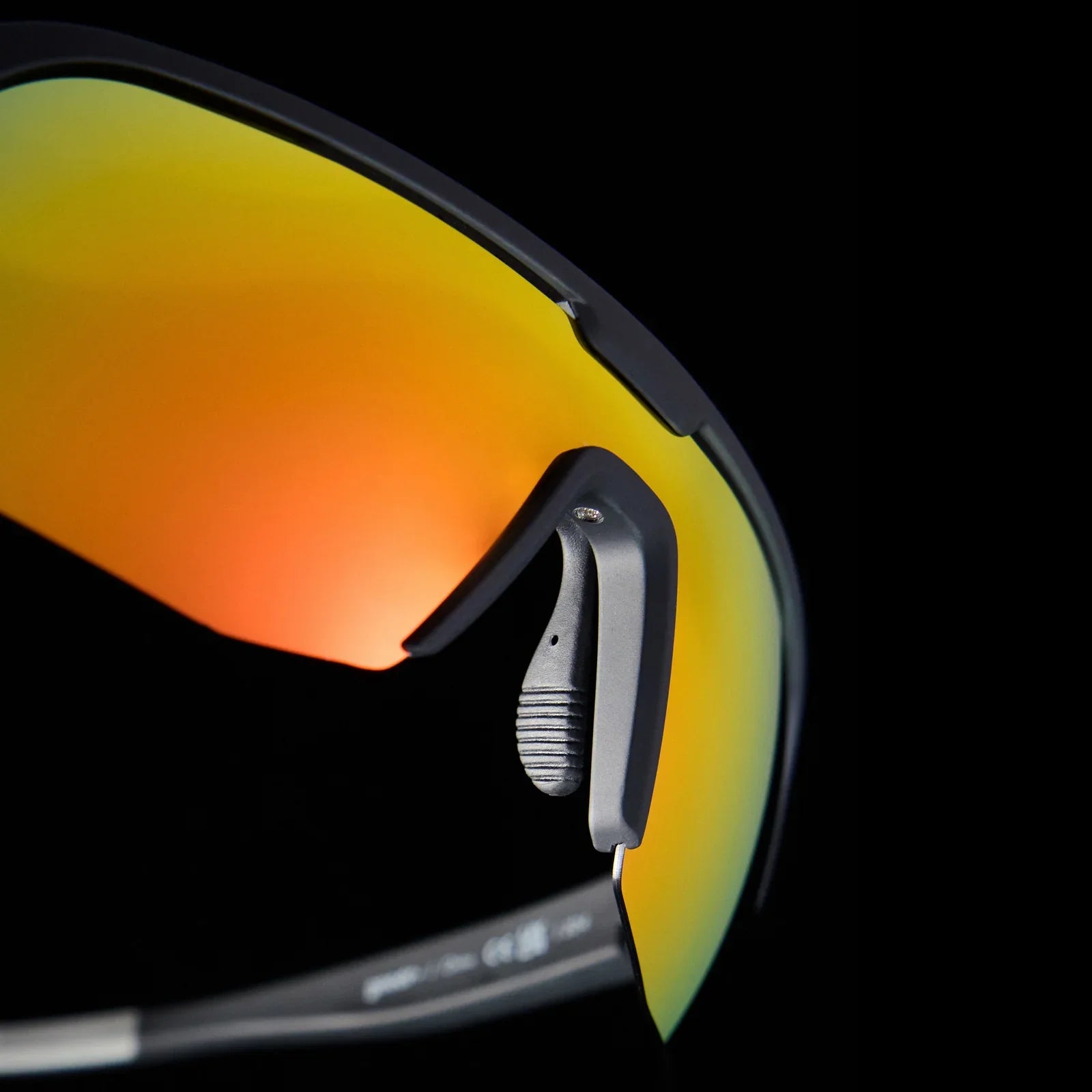 Goodr Bolt G: Do It For The Victory Dance Close-up of sunglasses with reflective orange and yellow on a black background