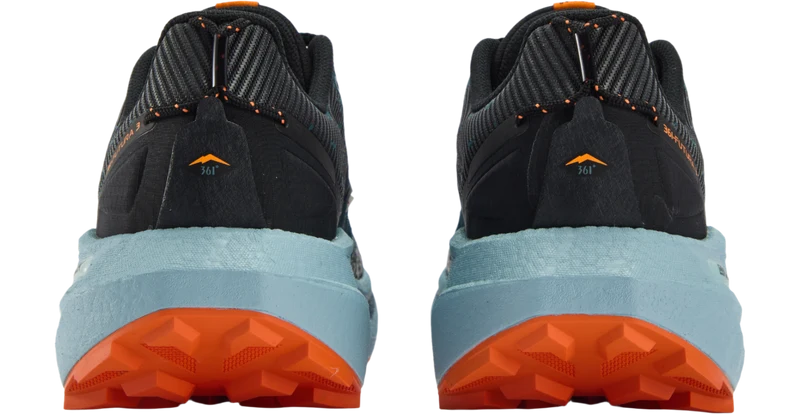 Rear view of a pair of trail running shoes showing the midsole and heel counter. The shoes feature a black and dark gray upper, a light blue midsole, and an orange outsole.