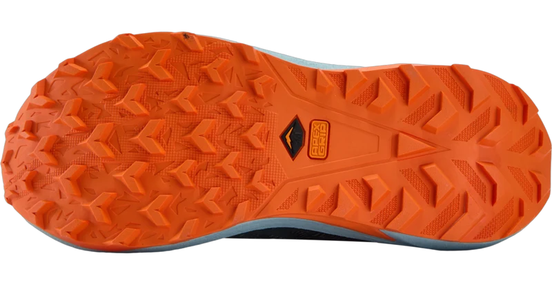 Close-up of the outsole of a trail running shoe, showing a bright orange tread pattern with a black and orange Vibram logo in the center, on a white background.