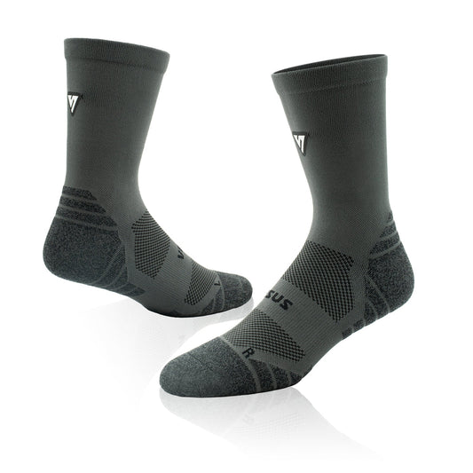 A pair of dark gray athletic crew socks with textured knit patterns and a small white logo on the side, displayed on a clean white background with a soft reflection.