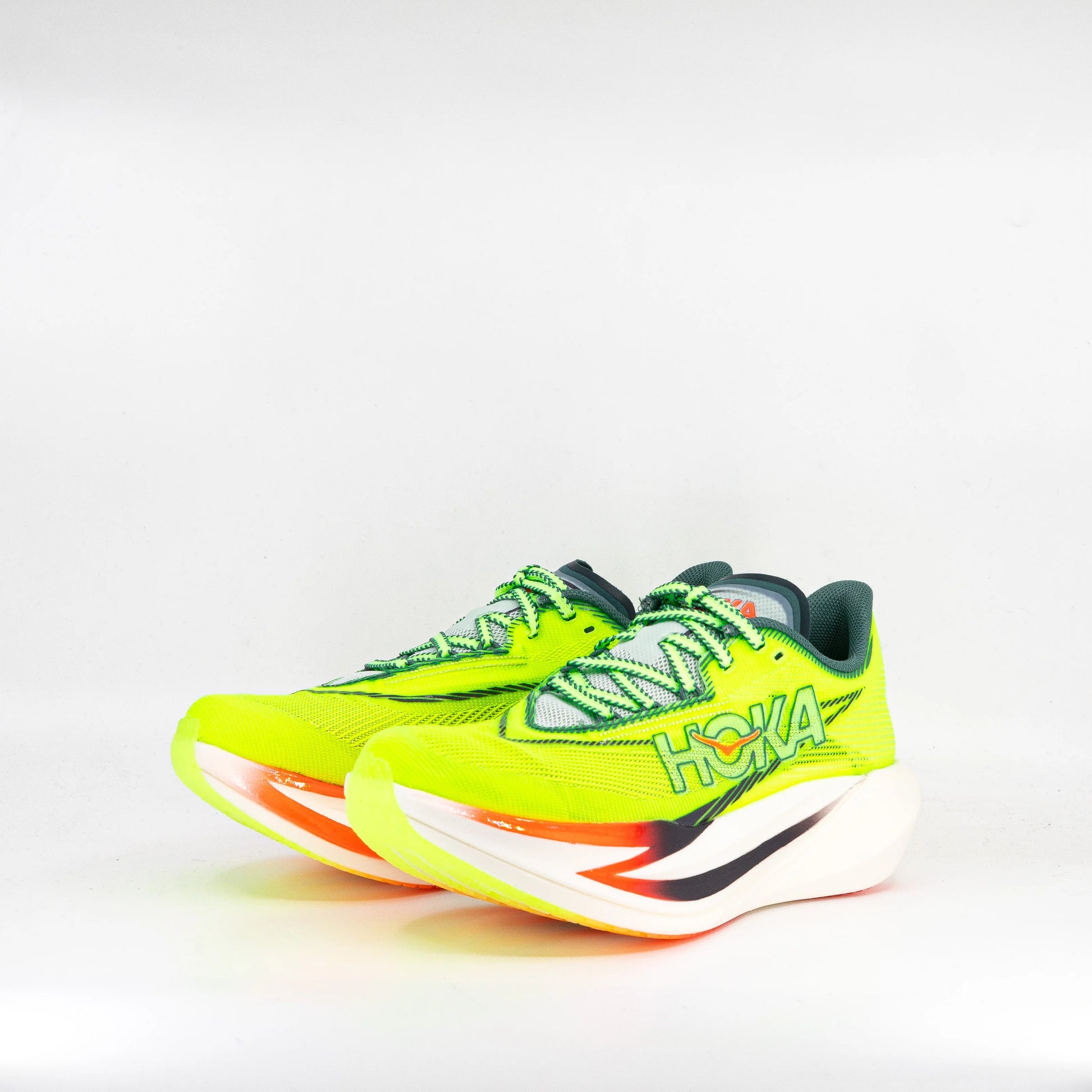 Brightly colored running shoes with 'Hoka' branding on a white background