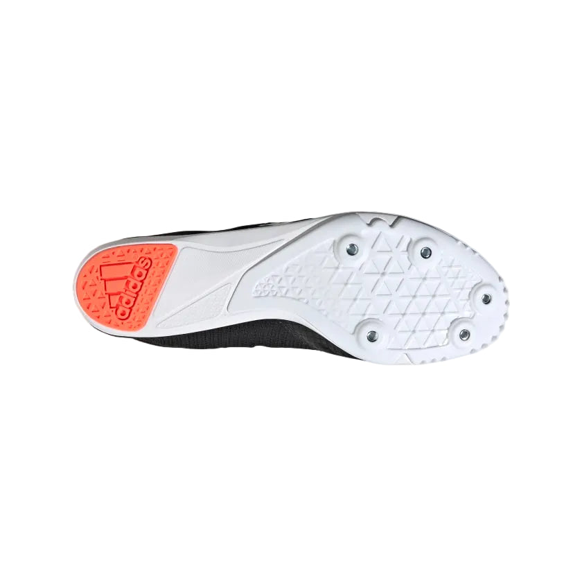 White athletic shoe with orange sole on a light gray background