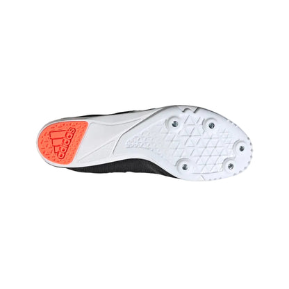 White athletic shoe with orange sole on a light gray background