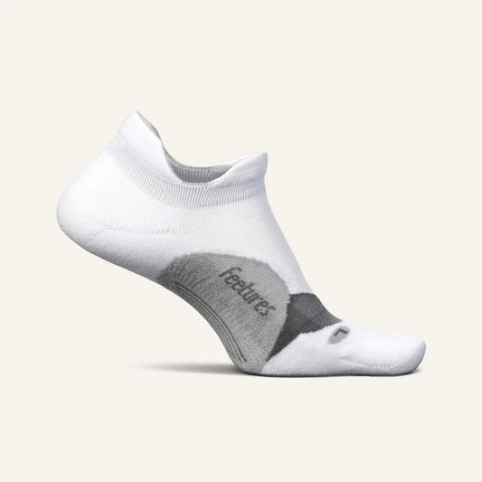A pair of white Feetures Elite Light Cushion No Show socks with targeted arch compression and a seamless heel.