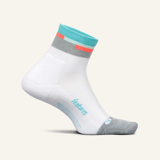 A white pair of Feetures Elite Light Cushion Quarter socks with blue and red accents near the ankle, and gray at the toe.