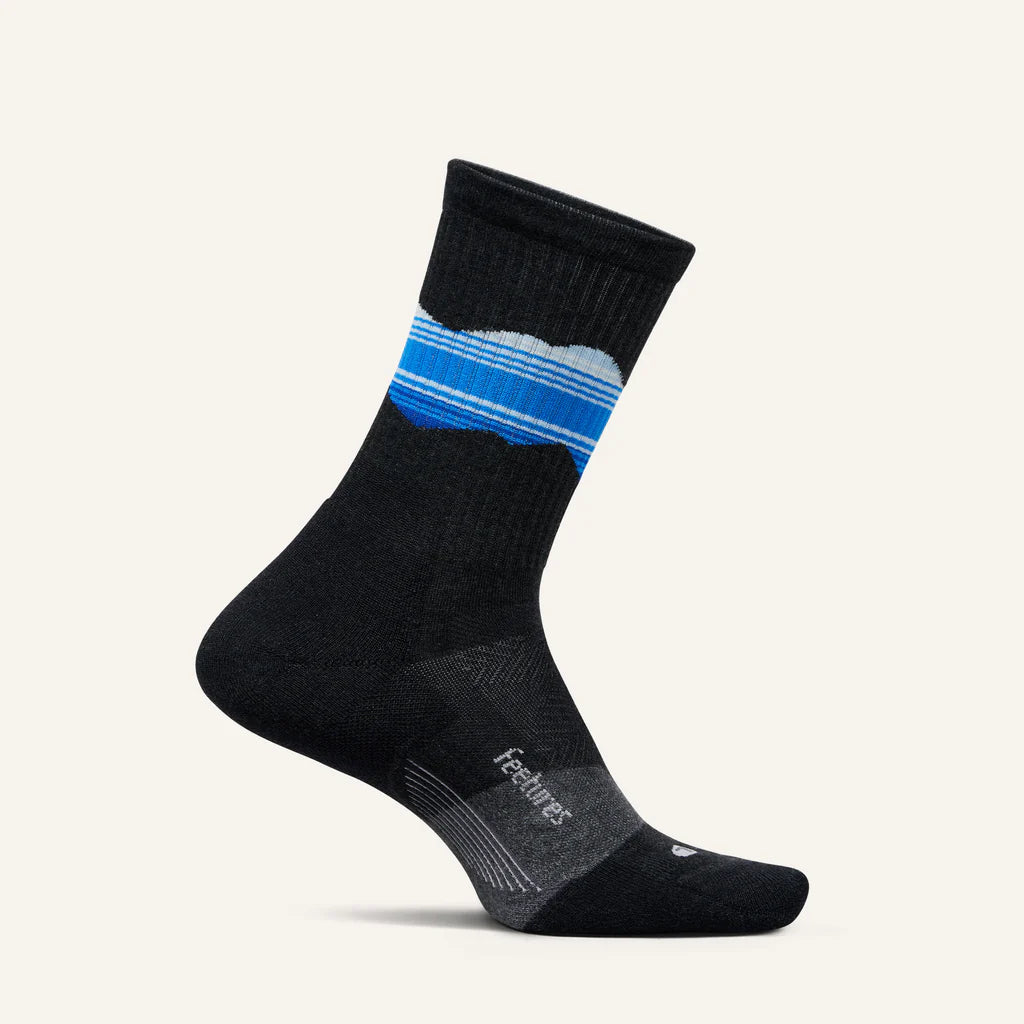 A pair of Feetures Trail Max Cushion Mini Crew socks in Blue Ridge Charcoal color, featuring a seamless heel and reinforced construction.