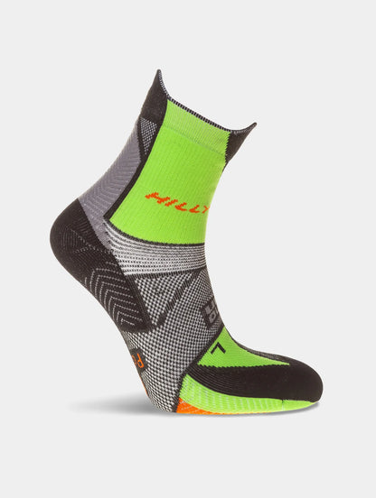 Black and green sock with orange accents on a light gray background