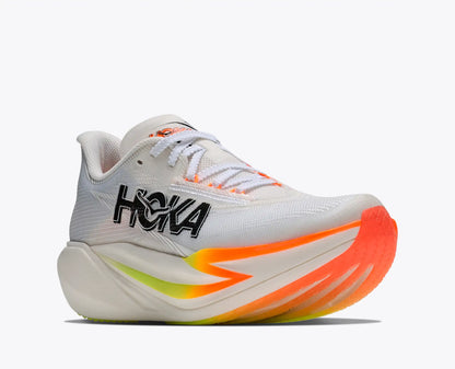 A Hoka Cielo running shoe in white with vibrant orange, yellow, and green accents on the sole, and a black Hoka logo on the side, set against a plain light gray background.
