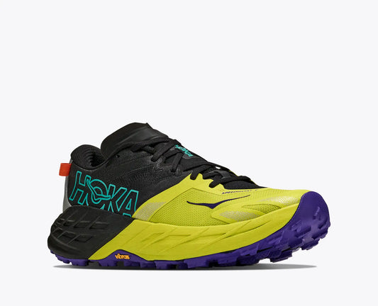 A Hoka Men's Speedgoat 7 trail running shoe in a vibrant lime yellow, black, and purple colorway, shown from a side profile on a light gray background.