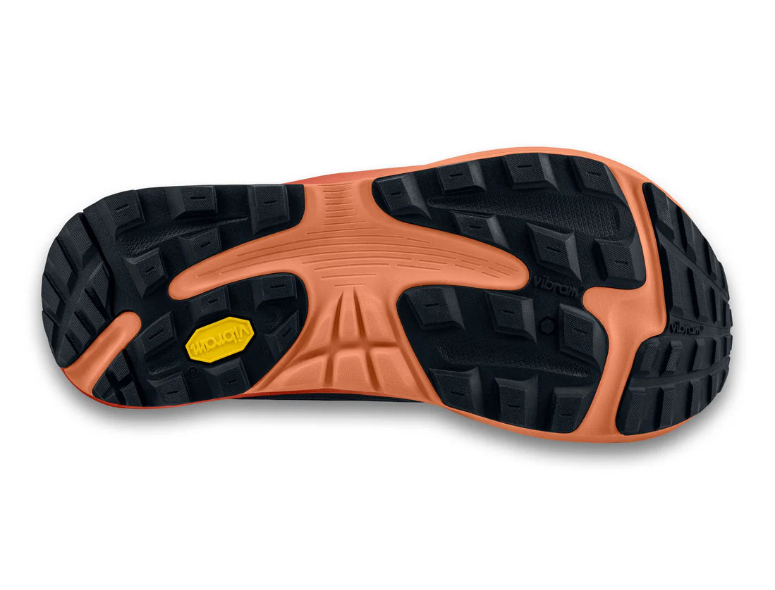 Close-up of a shoe sole with orange and black tread pattern on a white background