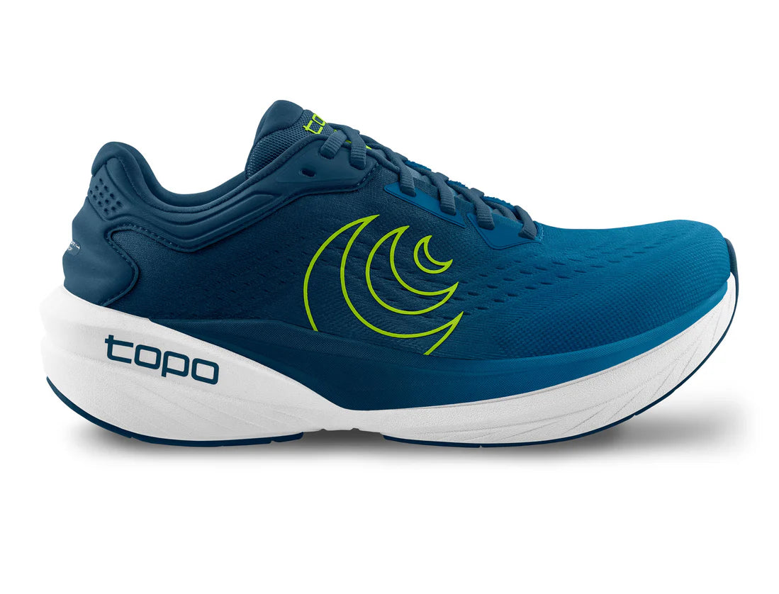 Blue running shoe with a white sole and green logo on a white background