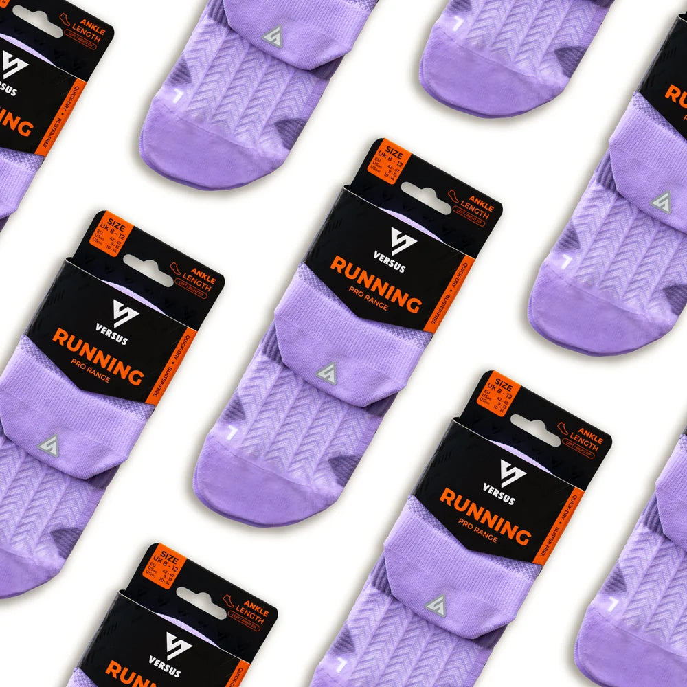 Purple running socks with Versus packaging on a white background