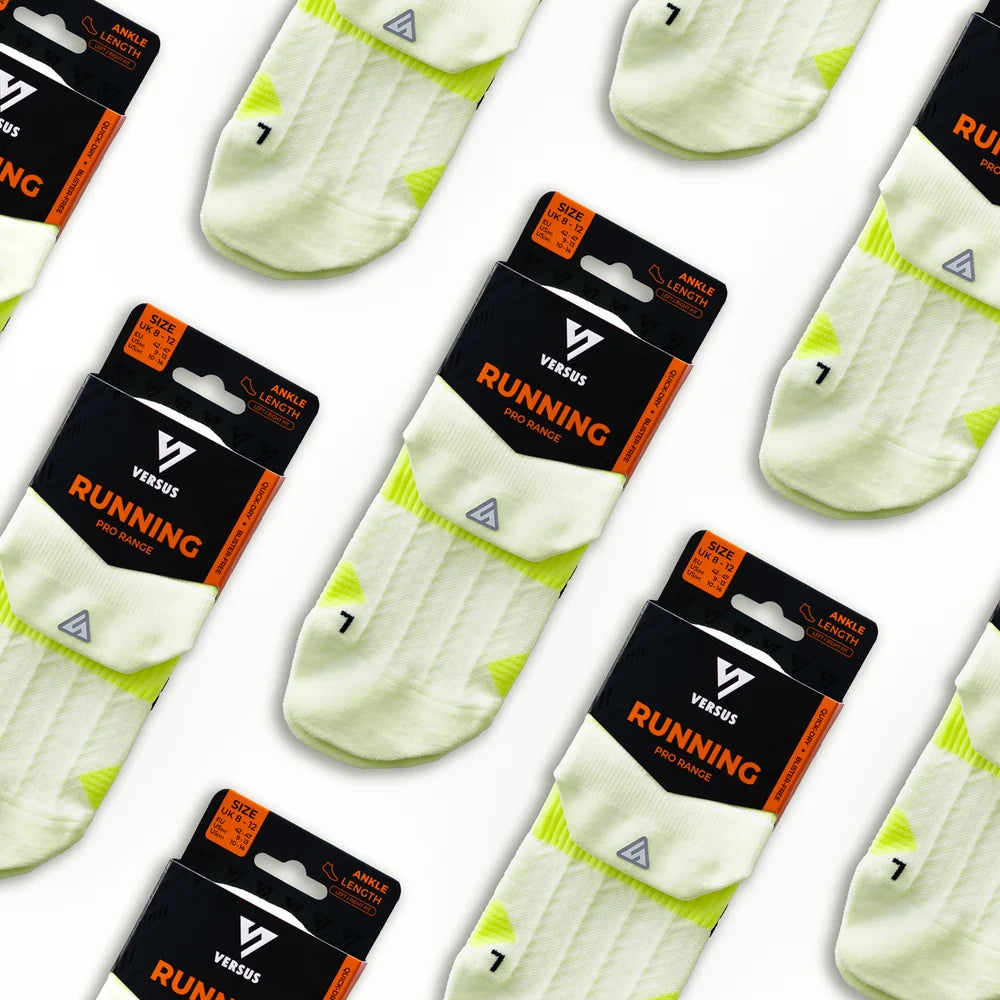 Versus running socks with yellow accents and packaging on a white background