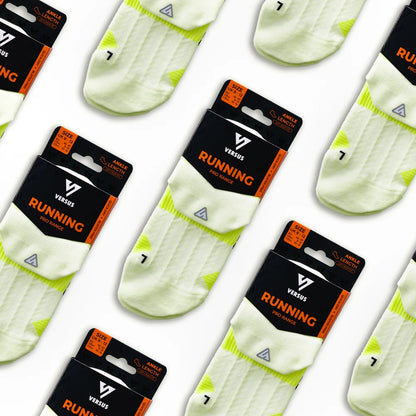 Versus running socks with yellow accents and packaging on a white background