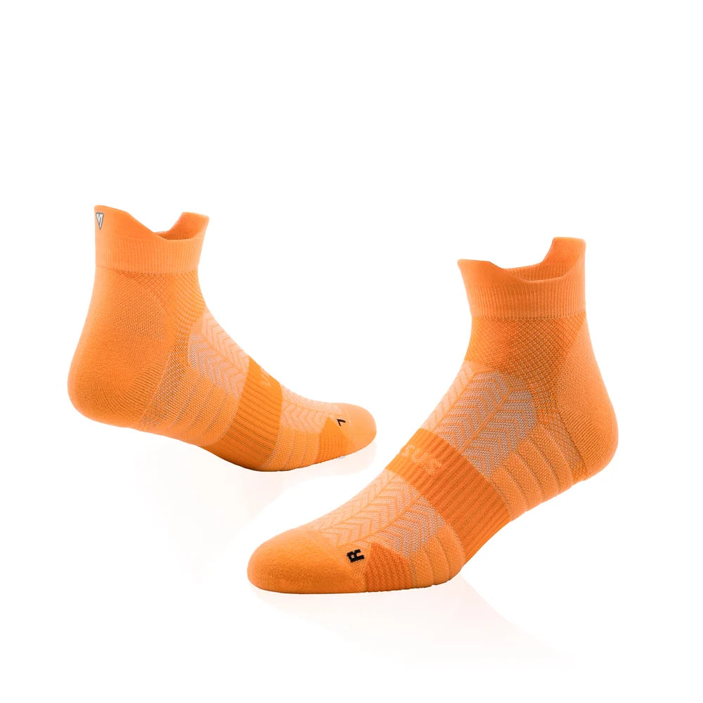 Pair of orange socks on a white background
