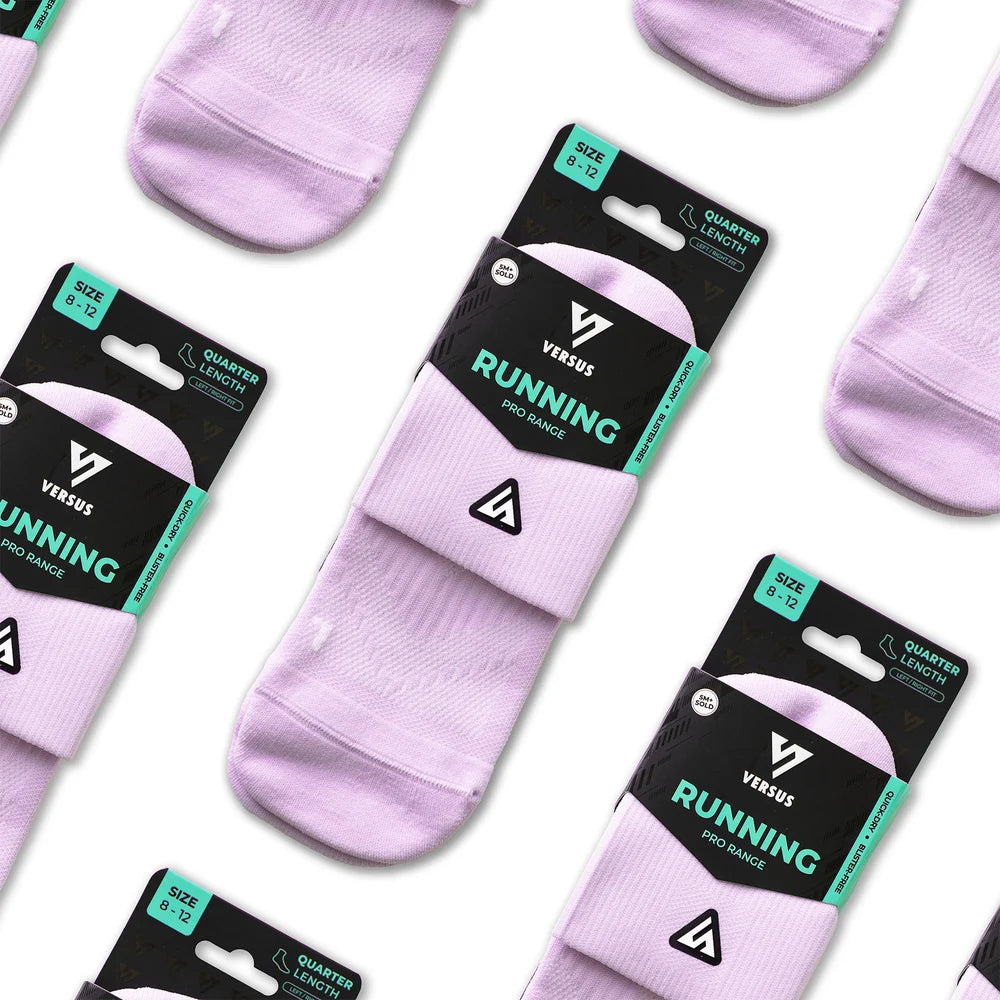 Three pairs of Versus Running quarter-length athletic socks in a light lavender purple color, packaged on black and teal cardboard hangers and arranged diagonally on a white background.