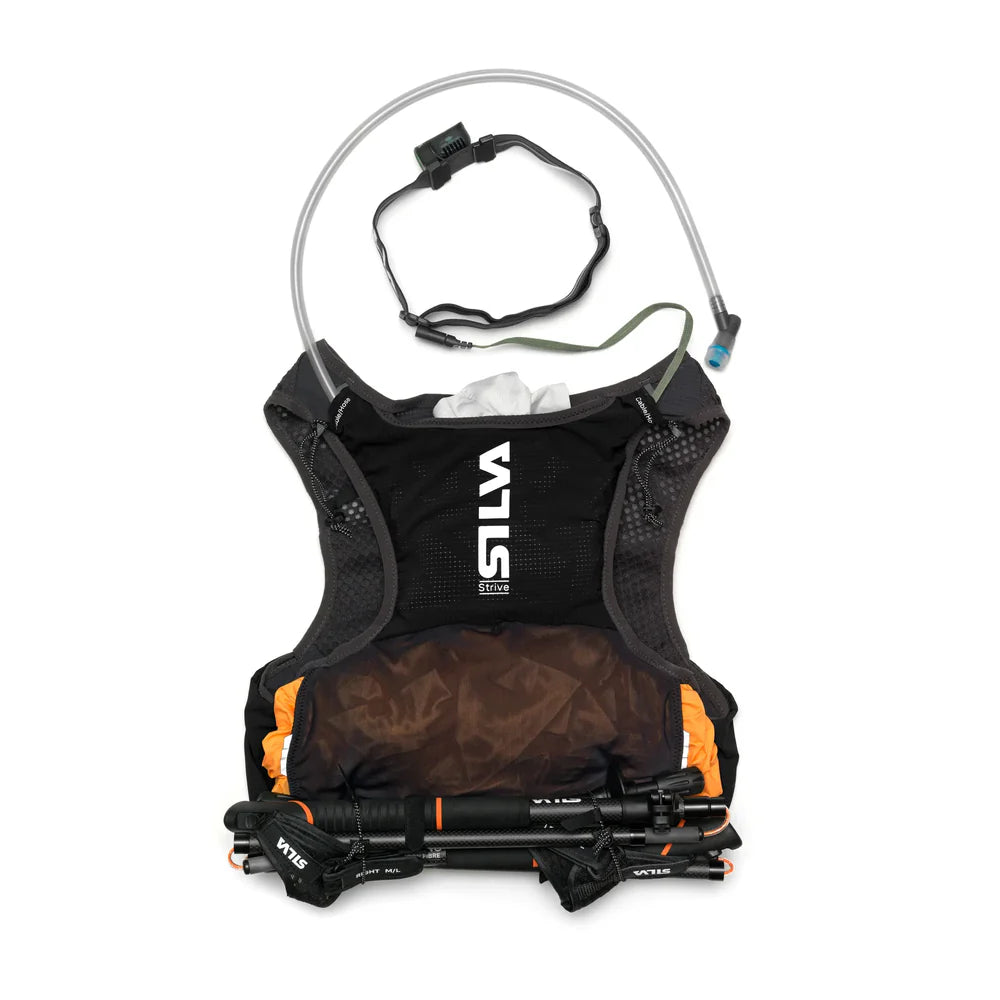 Silva hydration vest with water bottle and trekking poles on a white background