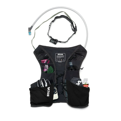Black hydration vest with gloves and water bottle on a white background