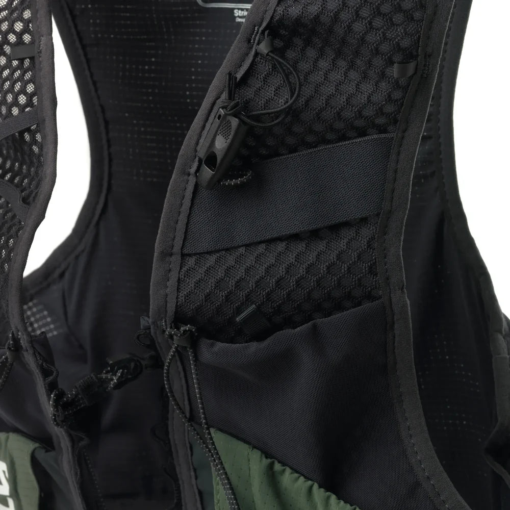 Close-up of the back panel of a black running vest with breathable mesh padding, an adjustable hook-and-loop strap, and a drawcord pocket, shown against a white background.