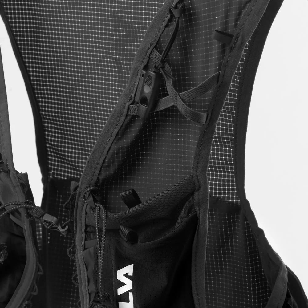 Close-up of a black backpack with visible branding on a white background