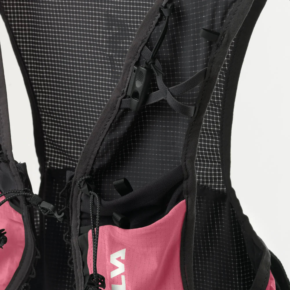 Close-up of a black and pink backpack with visible brand logo on a gray background