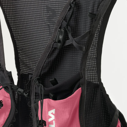 Close-up of a black and pink backpack with visible brand logo on a gray background