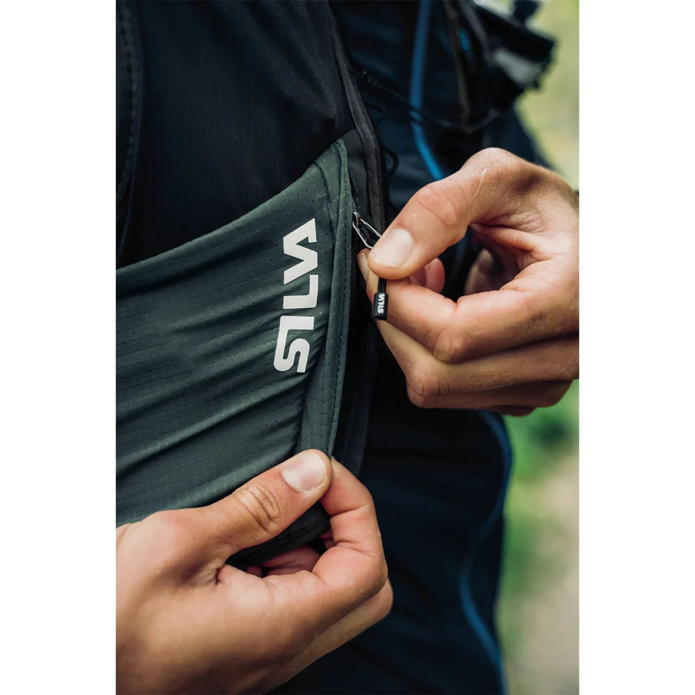 Person adjusting a Silva backpack in an outdoor setting