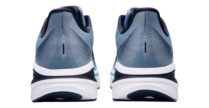 Blue running shoes with white soles on a white background