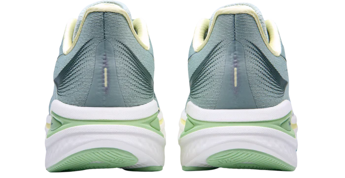 Pair of green running shoes with white soles on a white background