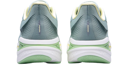 Pair of green running shoes with white soles on a white background