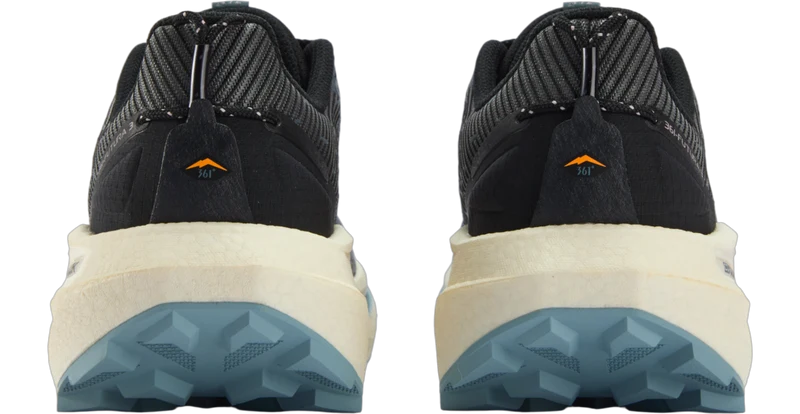 A pair of hiking shoes shown from the back, featuring a black and gray knit upper, a cream midsole, and a blue-gray lugged outsole.