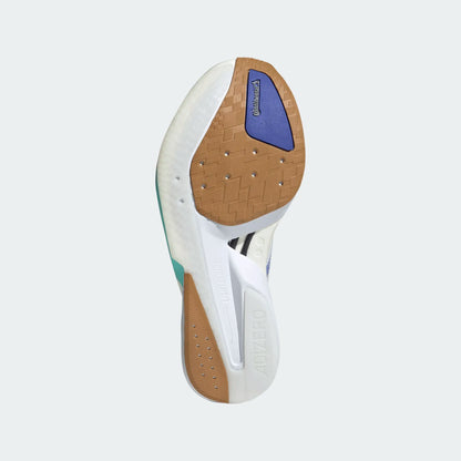 Close-up of a shoe sole with white, brown, and blue colors on a light gray background