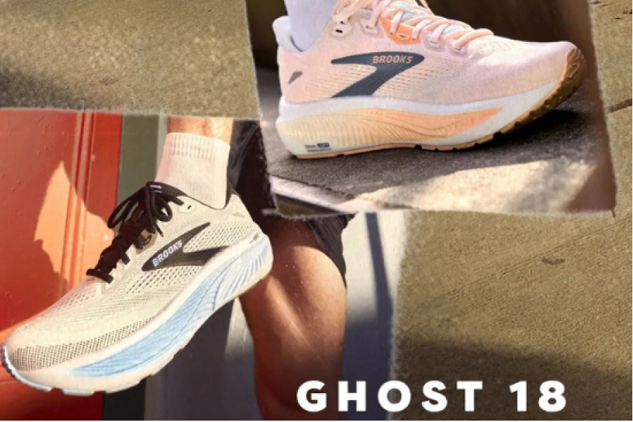 Person wearing Brooks Ghost 18 running shoes on a reflective surface with 'Brooks' branding.