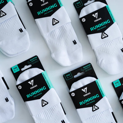 White socks with black packaging labeled 'Versus Running' on a light gray background