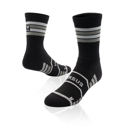 Black socks with white stripes and 'Versus' branding on a white background