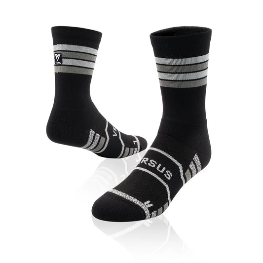 Black socks with white stripes and 'Versus' branding on a white background